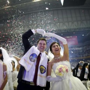 A newlywed couple celebrates during a mass wedding ceremony of the Unification Church at Cheongshim Peace World Centre in Gapyeong, South Korea, February 20, 2016. REUTERS/Kim Hong-Ji